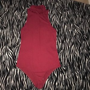 A ribbed bodysuit with a mid turtle neck